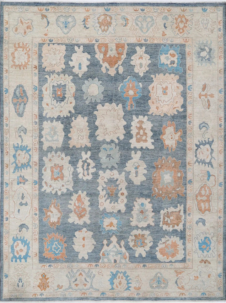 Hand-knotted Oushak wool rug with large open design in luminous soft tones