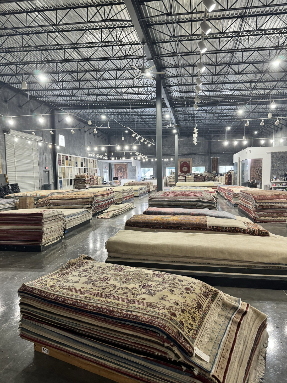 Inside the Arteverk Houston showroom, rugs laid out in the gallery